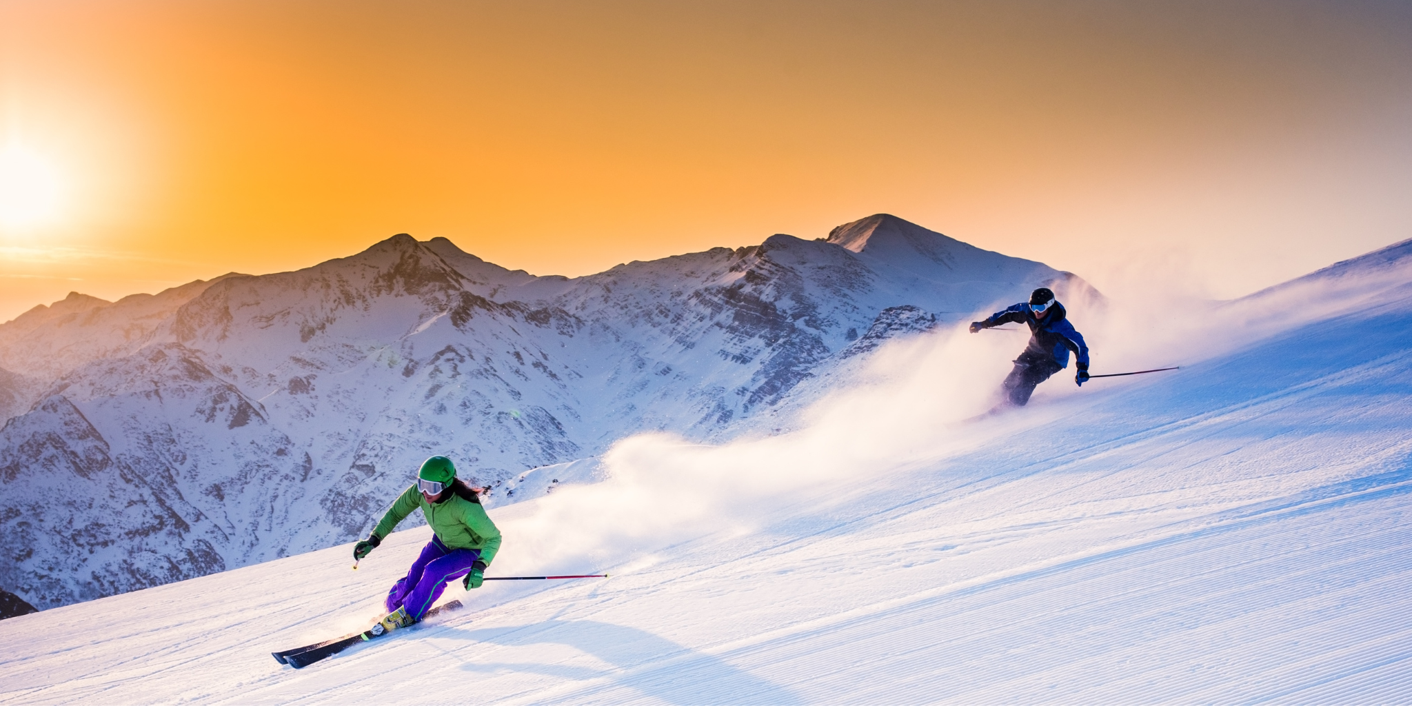 two skiers skiing on piste on rental ski they hired in queenstown and wanaka