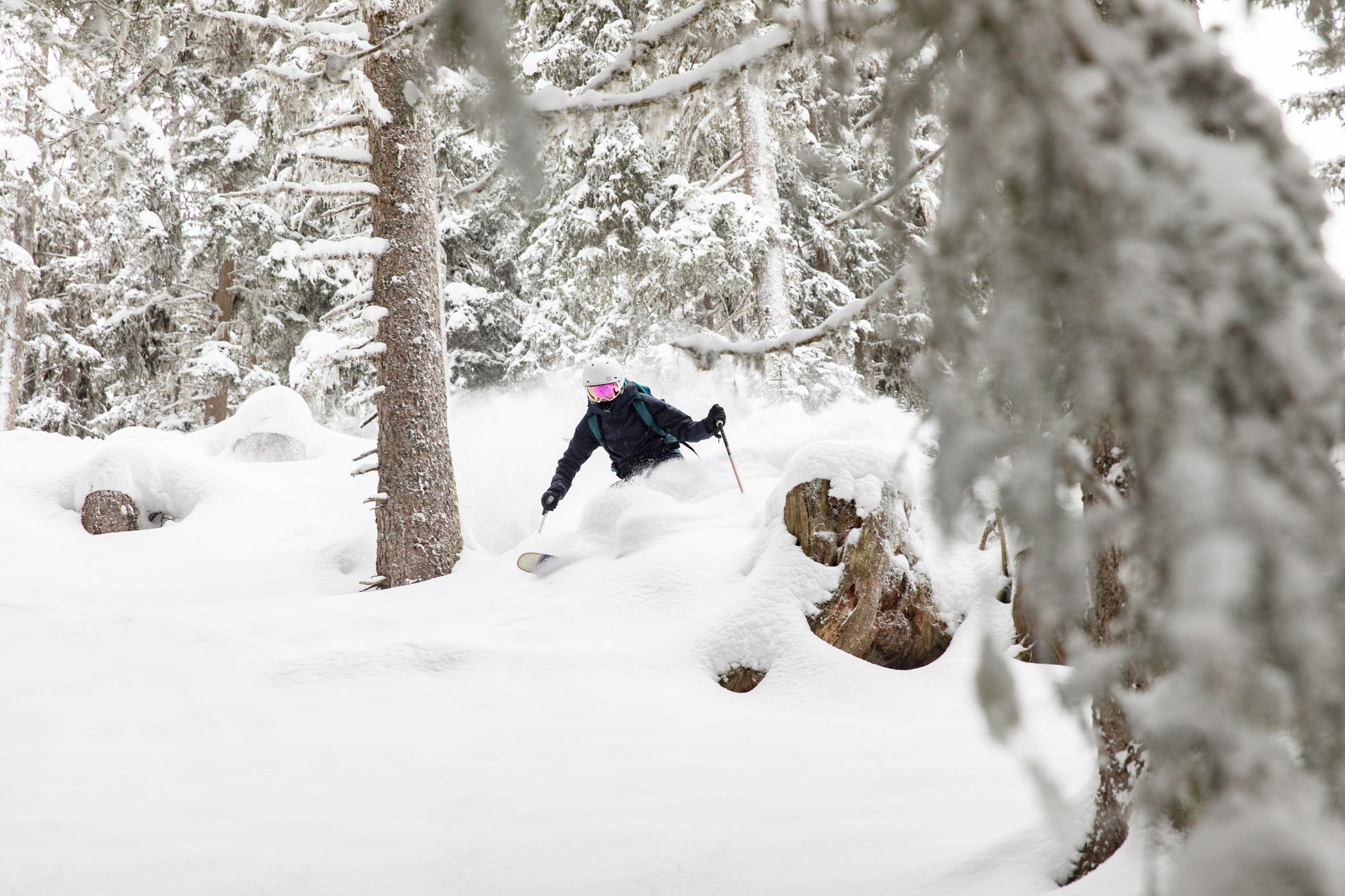 someone skiing powder in the trees on rossignol skis