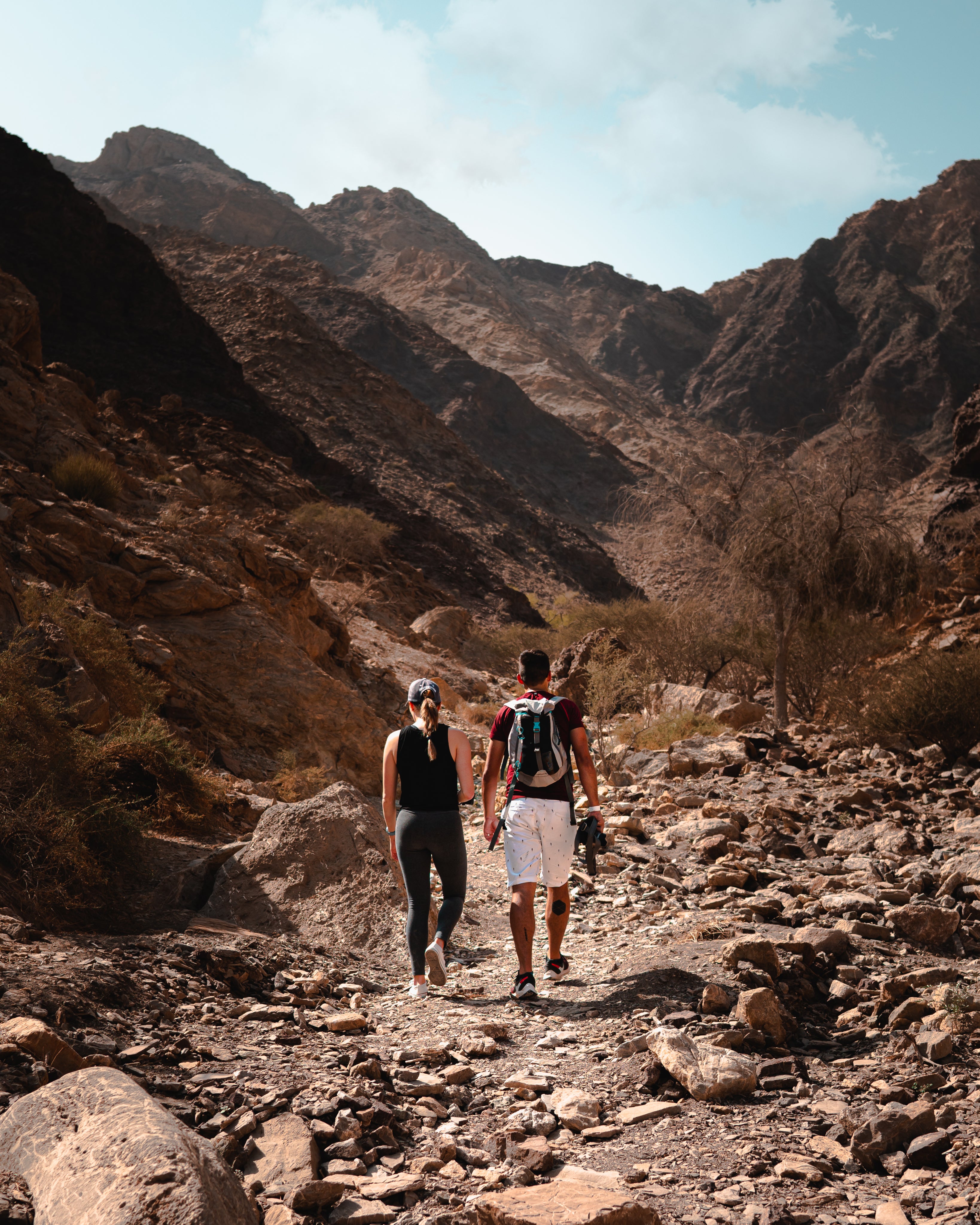 two-people-hiking-on-a-rustic-trail - Outside Sports